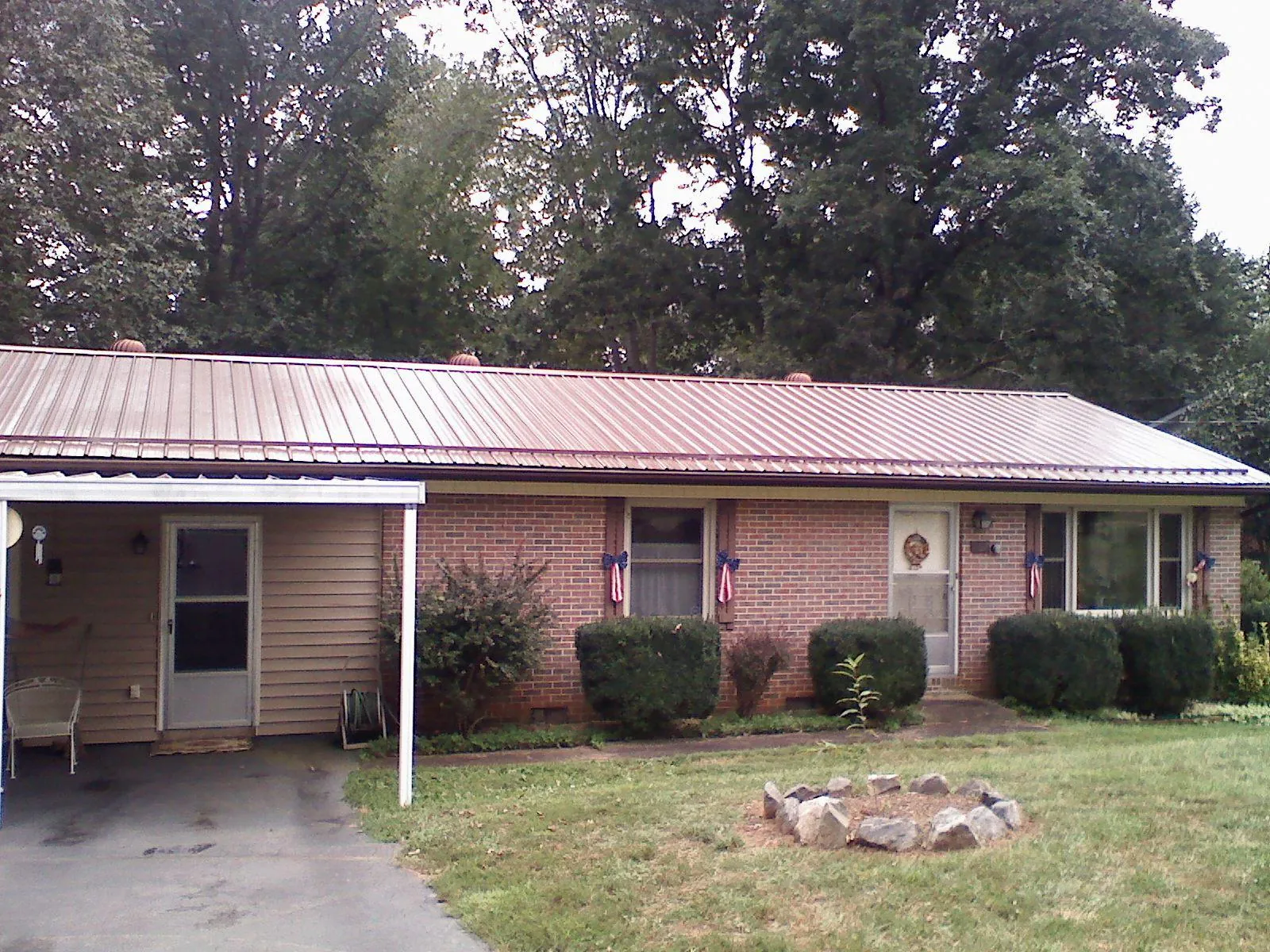 Bronze metal roof and carport on a brick ranch home — Roof Repair work by our crew in Stevenson